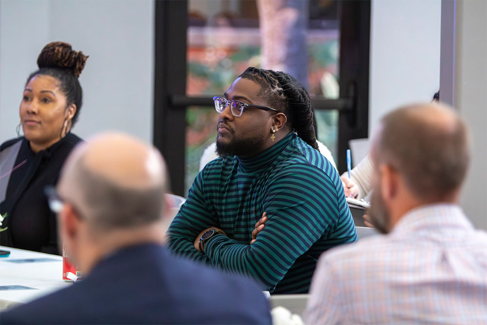 man in glasses listening to presentation